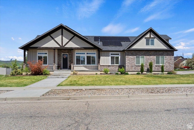 5707 Scenic Ln, Mountain Green, UT 84050 - craftsman-style house featuring stone siding, board and batten siding, roof mounted solar panels, and a front lawn