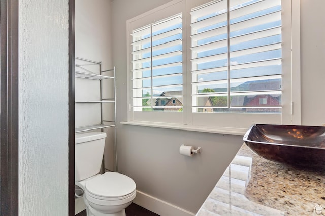 5707 Scenic Ln, Mountain Green, UT 84050 - half bathroom featuring toilet, baseboards, and a sink