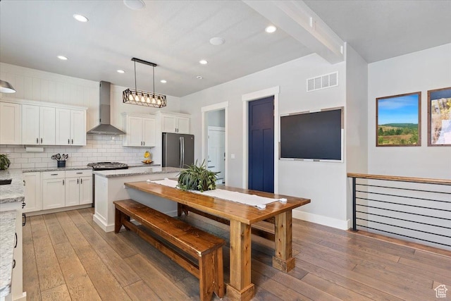 5707 Scenic Ln, Mountain Green, UT 84050 - kitchen with wall chimney range hood, freestanding refrigerator, hardwood / wood-style flooring, white cabinets, and recessed lighting