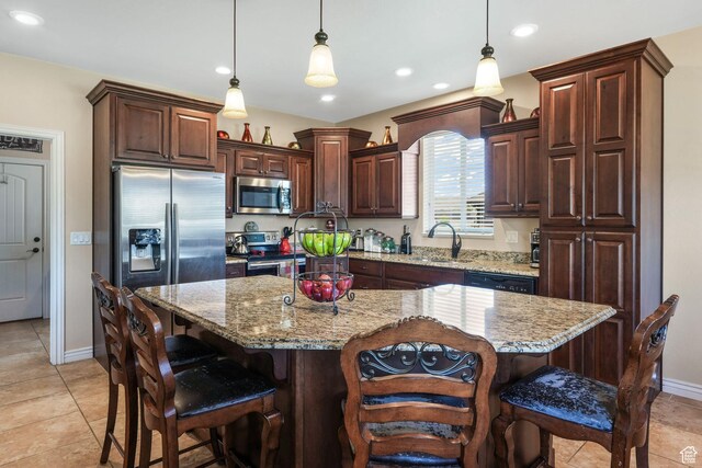 kitchen with stainless steel appliances, a breakfast bar, light tile patterned flooring, baseboards, and recessed lighting