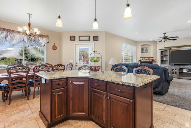 kitchen featuring light tile patterned floors, a chandelier, decorative light fixtures, and a ceiling fan
