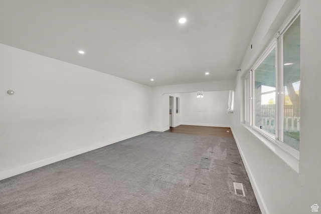 unfurnished room featuring carpet, recessed lighting, and baseboards