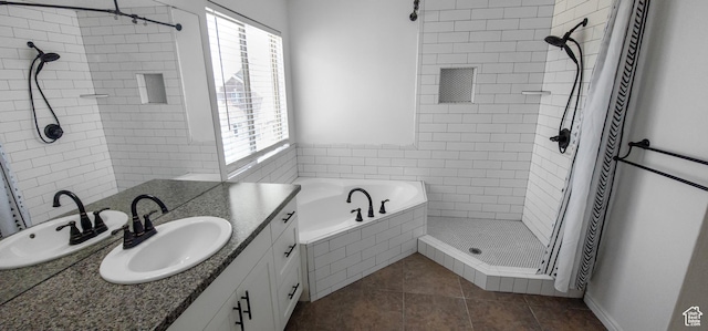 full bathroom with a stall shower, tile patterned flooring, vanity, and a relaxing tiled tub