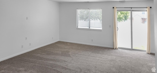carpeted spare room with baseboards