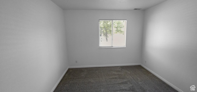 carpeted empty room with baseboards