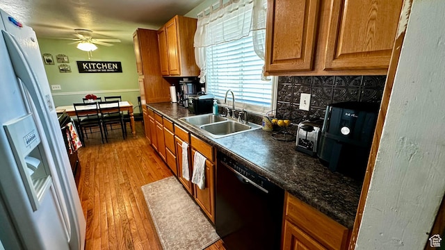 874 W 300 S, Vernal, UT 84078 - kitchen featuring a sink, black dishwasher, white fridge with ice dispenser, a ceiling fan, and backsplash