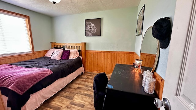 874 W 300 S, Vernal, UT 84078 - bedroom featuring wood finished floors, wood walls, a wainscoted wall, and a textured ceiling