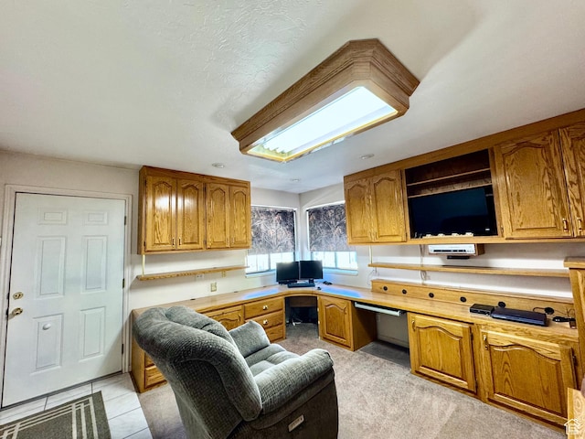 kitchen featuring brown cabinetry, open shelves, and light countertops