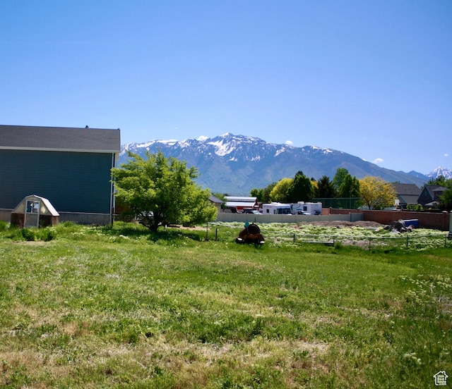 view of yard with a mountain view and fence