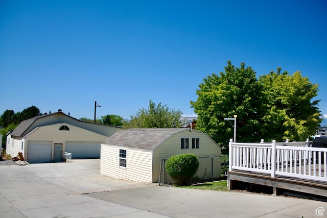 detached garage featuring fence