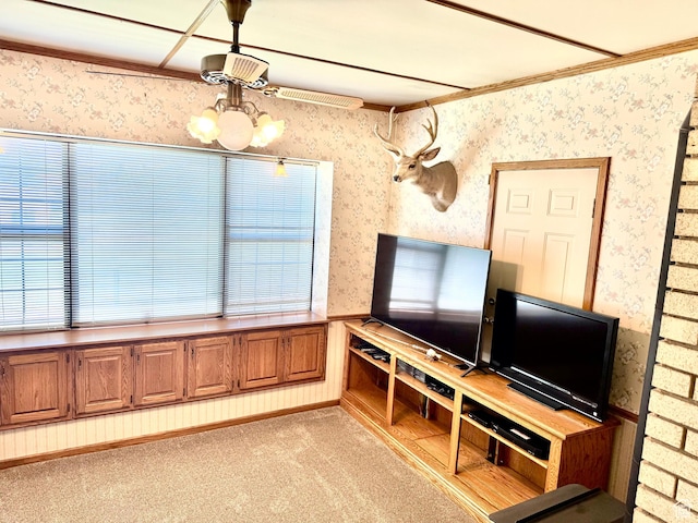 unfurnished living room featuring wallpapered walls, a chandelier, light carpet, and crown molding