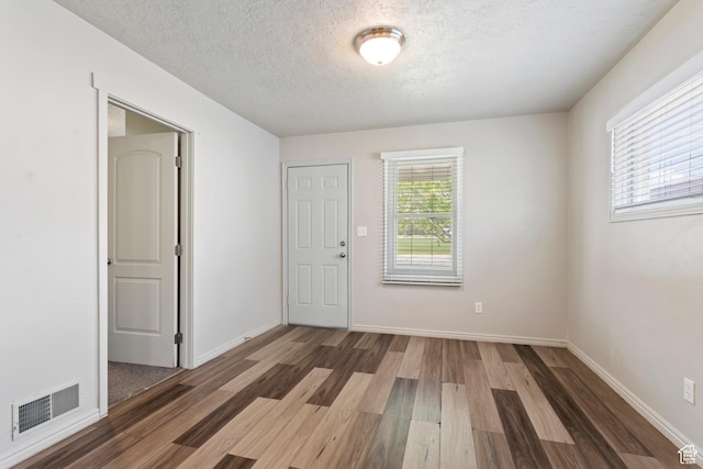 41 N 400 E, Brigham City, UT 84302 - empty room featuring wood finished floors, a textured ceiling, and baseboards