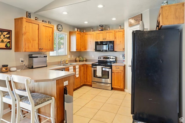 1424 W 3325 S, Perry, UT 84302 - kitchen featuring black appliances, a peninsula, a sink, light countertops, and recessed lighting