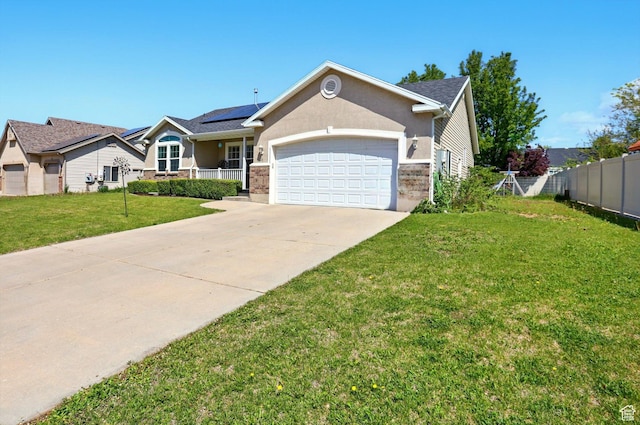1424 W 3325 S, Perry, UT 84302 - ranch-style house with a garage, concrete driveway, solar panels, and stucco siding