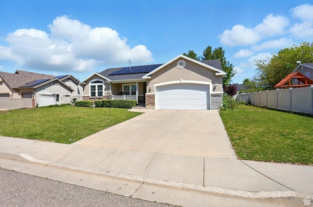 1424 W 3325 S, Perry, UT 84302 - view of front of property featuring roof mounted solar panels, an attached garage, driveway, and a porch