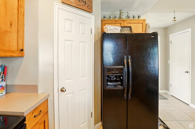 1424 W 3325 S, Perry, UT 84302 - kitchen featuring black refrigerator with ice dispenser, light tile patterned floors, light countertops, baseboards, and electric range
