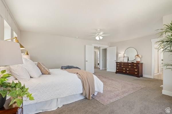 carpeted bedroom with baseboards and ceiling fan