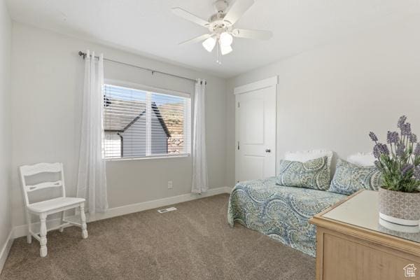 carpeted bedroom featuring baseboards and ceiling fan