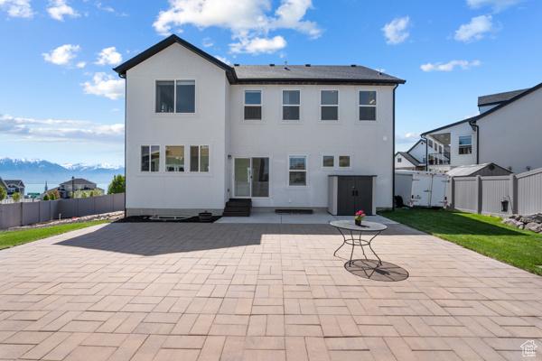 back of house with a patio area, entry steps, a fenced backyard, and stucco siding