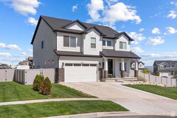 view of front of property featuring a garage, driveway, a gate, and a residential view