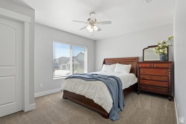 carpeted bedroom with baseboards and a ceiling fan