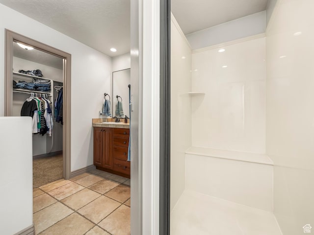 636 Quartz Dr, Santaquin, UT 84655 - bathroom with vanity, a spacious closet, walk in shower, and tile patterned flooring