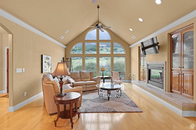 395 S 200 E, Willard, UT 84340 - living room featuring a ceiling fan, light wood-type flooring, a glass covered fireplace, arched walkways, and baseboards