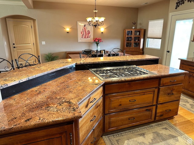 395 S 200 E, Willard, UT 84340 - kitchen with stainless steel gas stovetop, light wood-type flooring, a chandelier, and brown cabinetry