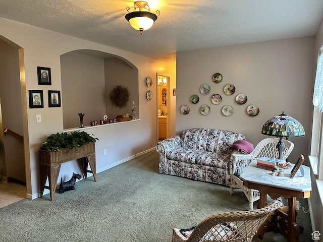 2756 S 725 W, Perry, UT 84302 - carpeted living area featuring arched walkways, baseboards, and a textured ceiling