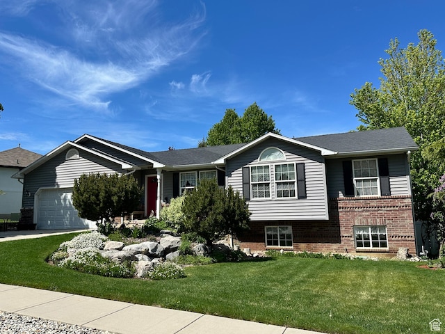 2756 S 725 W, Perry, UT 84302 - view of front facade with brick siding, a garage, a front lawn, and driveway