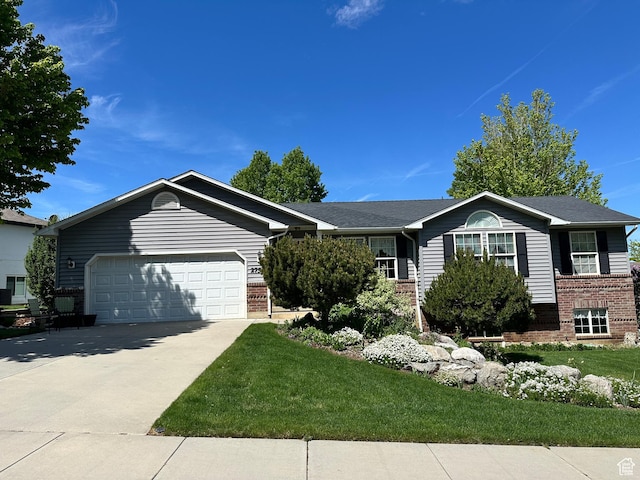 2756 S 725 W, Perry, UT 84302 - ranch-style house featuring brick siding, an attached garage, concrete driveway, and a front lawn