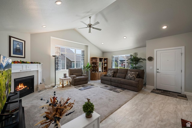 516 E Lone Star Ln Unit A, Saratoga Springs, UT 84045 - living room featuring lofted ceiling, plenty of natural light, a ceiling fan, a tile fireplace, and baseboards