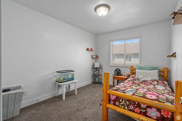 carpeted bedroom with a textured ceiling and baseboards