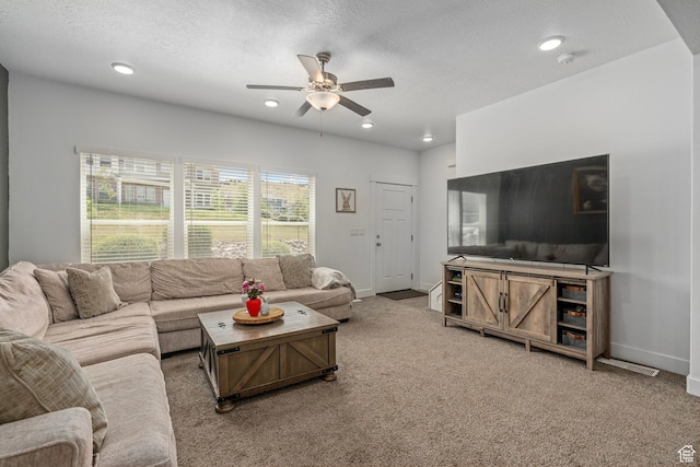 living room featuring a ceiling fan, light colored carpet, a textured ceiling, recessed lighting, and baseboards