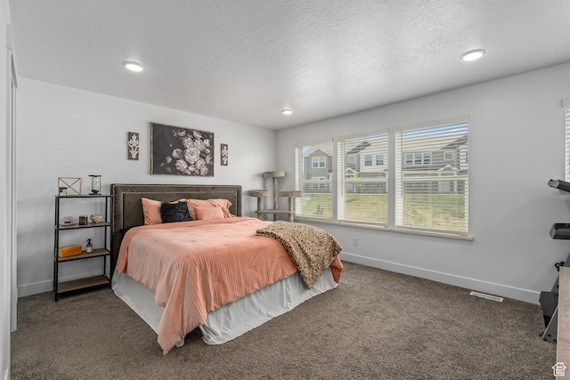 bedroom featuring a textured ceiling, baseboards, carpet, and recessed lighting
