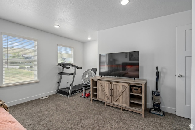 workout room featuring carpet flooring, a textured ceiling, baseboards, and recessed lighting