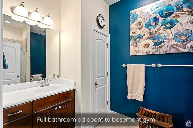 bathroom featuring vanity, toilet, and tile patterned flooring
