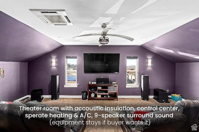 carpeted home theater room with vaulted ceiling, baseboards, and a ceiling fan