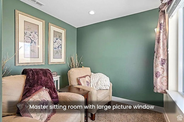 living area featuring carpet floors, baseboards, and recessed lighting