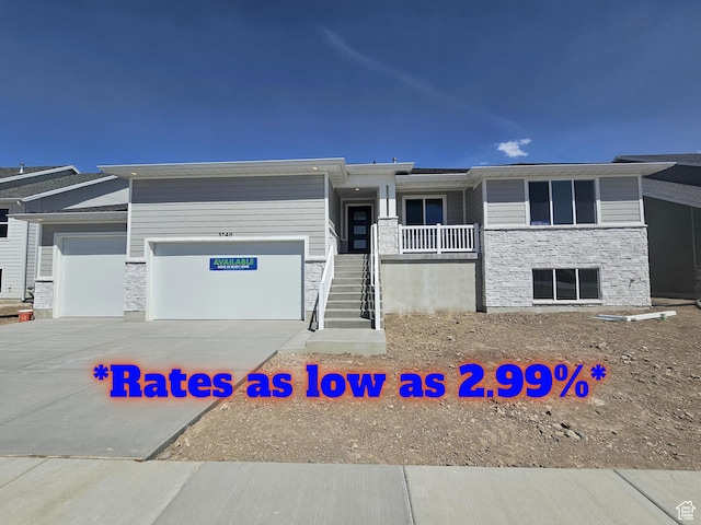 3148 N 2875 W Unit 29, Plain City, UT 84404 - view of front facade featuring an attached garage, stone siding, driveway, and stairs