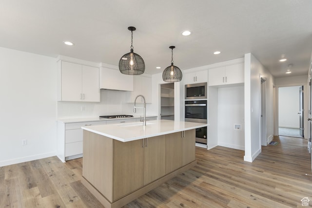 3148 N 2875 W Unit 29, Plain City, UT 84404 - kitchen with stainless steel appliances, a sink, light countertops, baseboards, and recessed lighting