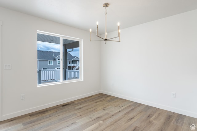 3148 N 2875 W Unit 29, Plain City, UT 84404 - unfurnished room with a chandelier, light wood-style floors, and baseboards