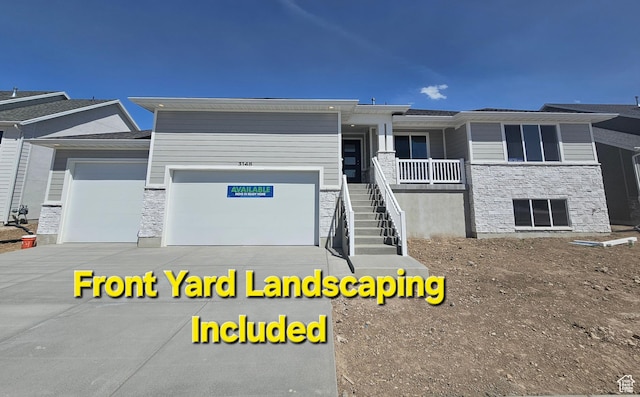 3148 N 2875 W Unit 29, Plain City, UT 84404 - view of front of house with an attached garage, concrete driveway, stone siding, and stairway