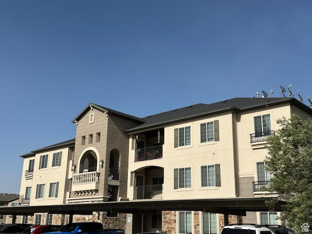 view of building exterior with covered parking