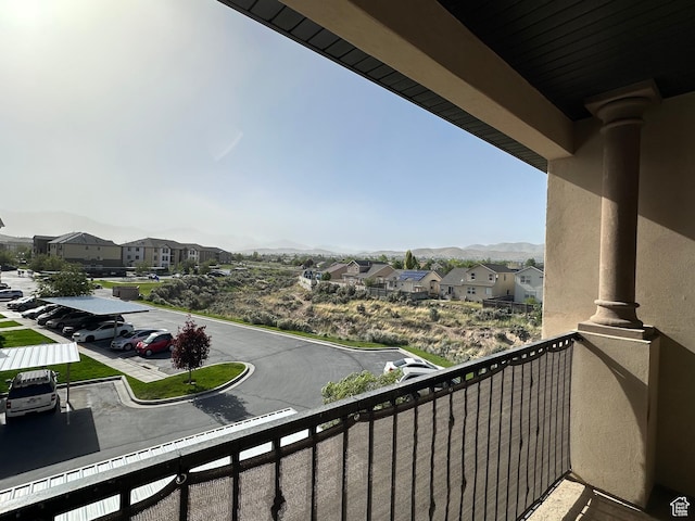 balcony with a residential view and a mountain view