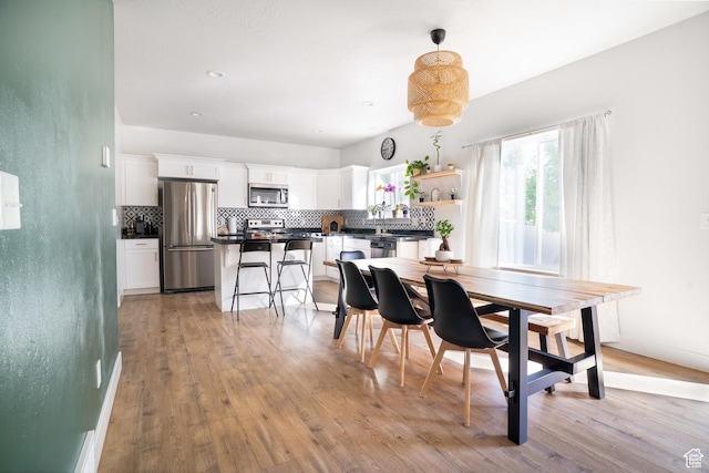 dining space featuring light wood-style floors