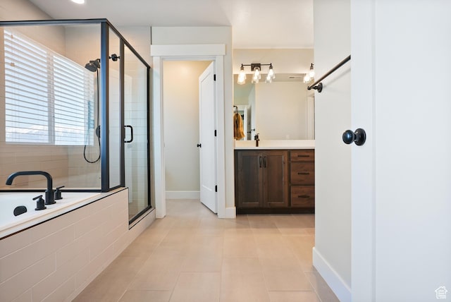 full bath featuring a stall shower, tile patterned floors, vanity, a bath, and baseboards