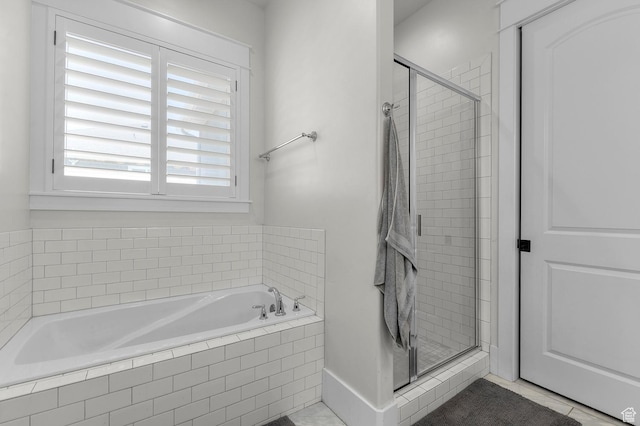 bathroom with a shower stall, a bath, and tile patterned floors