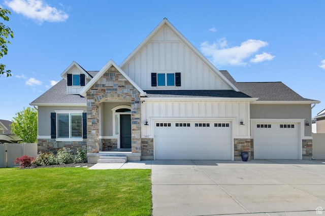 view of front facade with stone siding, board and batten siding, an attached garage, driveway, and roof with shingles