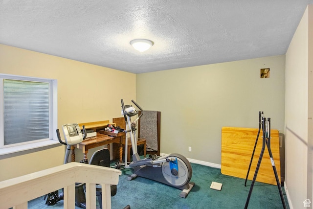workout area with carpet flooring, a textured ceiling, and baseboards